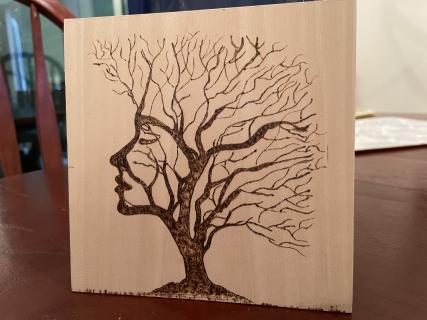 Womans Face in Trees